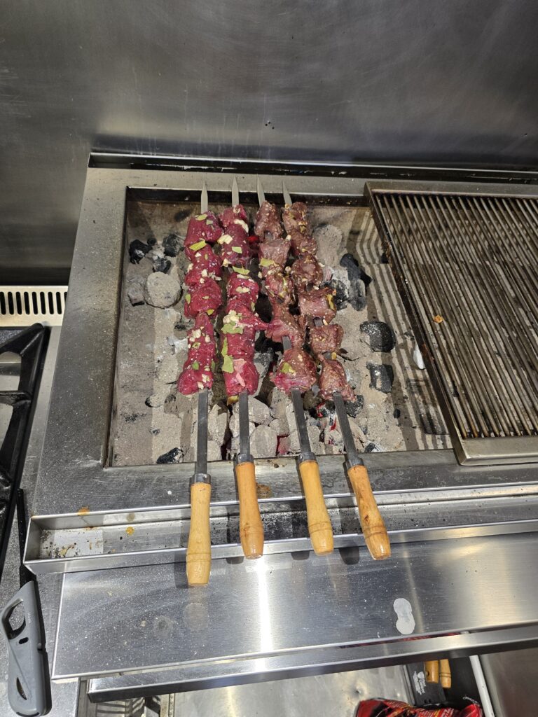 Beef espetada skewers prepared at NIKITA BAR & Kitchen